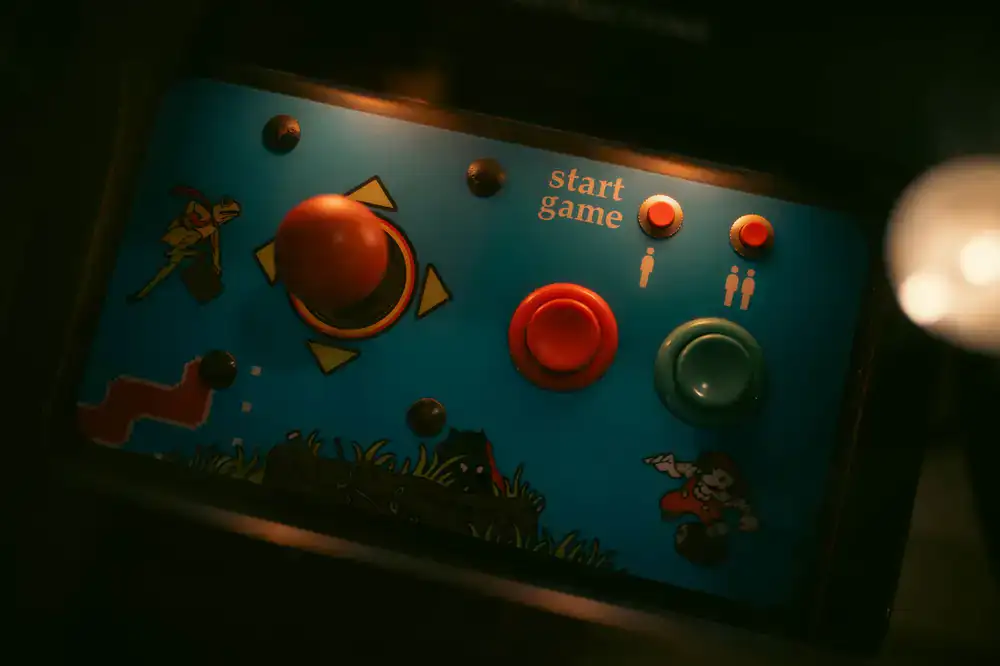 Gameplay screenshot showing a colorful bakery production line with upgrade buttons